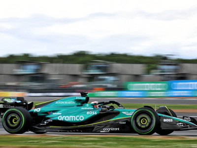 Aston Martin AMR Aramco branded F1 car in front of Escapade Silverstone