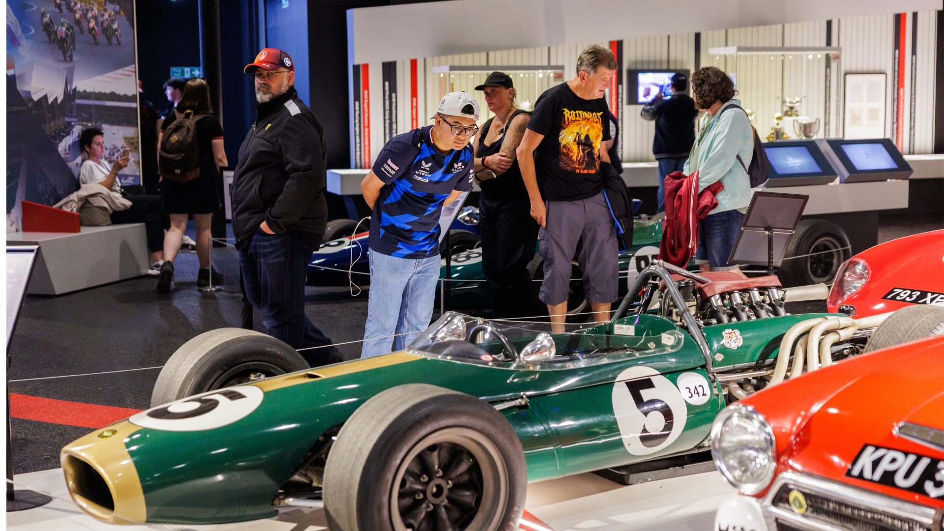 Visitor Looking At Car Exhibit
