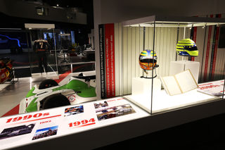 Memorabilia Display at Silverstone Museum with Racing Helmets and Viking Race Car