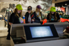 A group of young women interact with the touch screens at Silverstone Museum in the Tech Lab